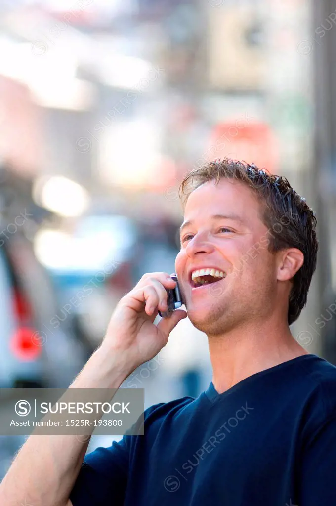 Man having lively conversation on cellphone on the street.