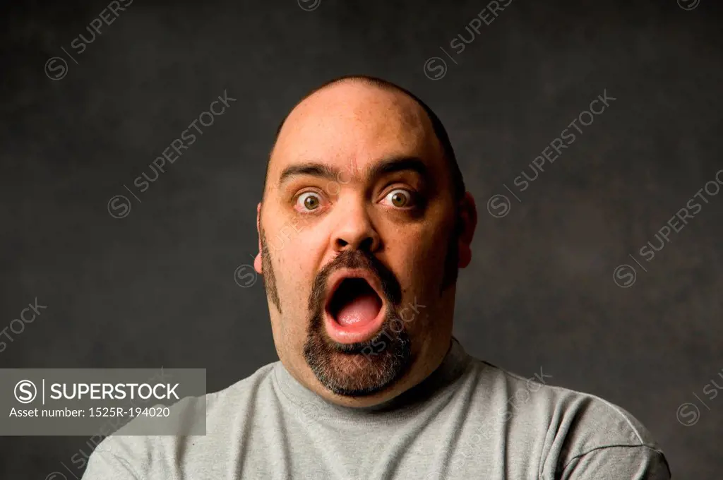 Close-up of surprised man's face, with open mouth.