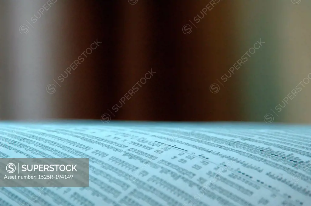 Newspaper stock page with blurred background.