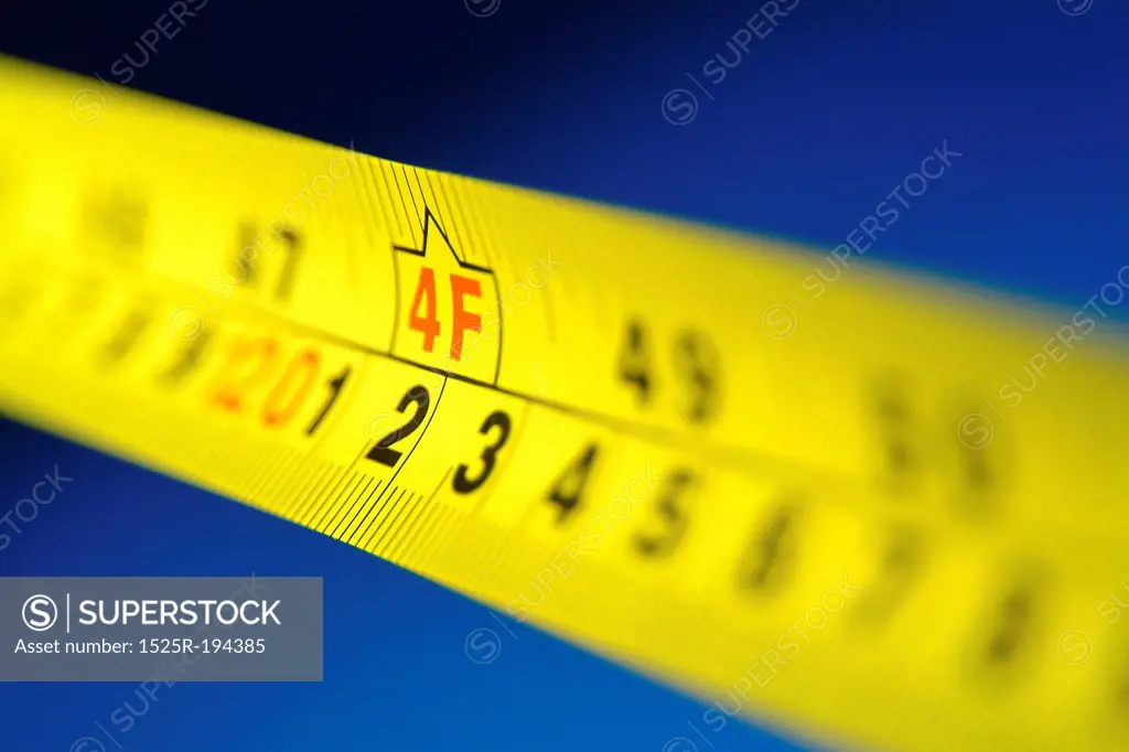 Yellow retractable measuring tape.