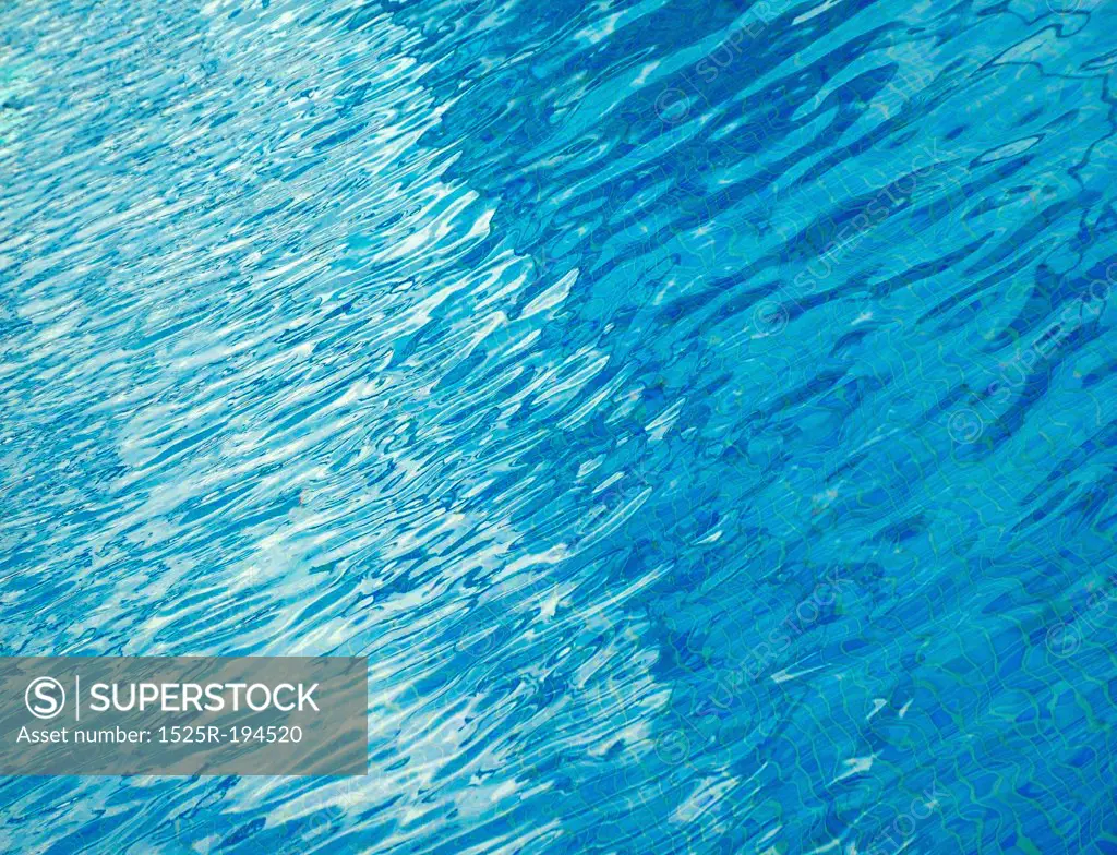 Abstract composition of blue pool water ripples.