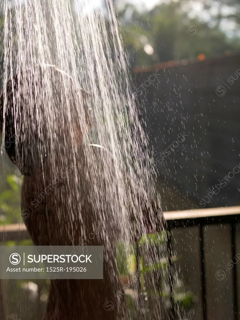 Woman taking an outdoor shower in Bali