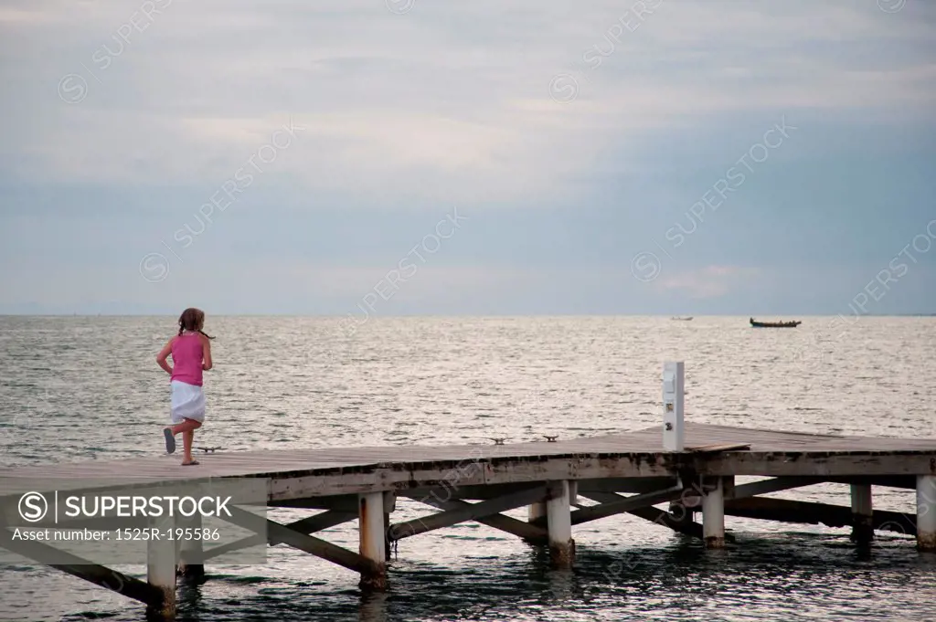 Young girl on a pier at Placencia in Belize