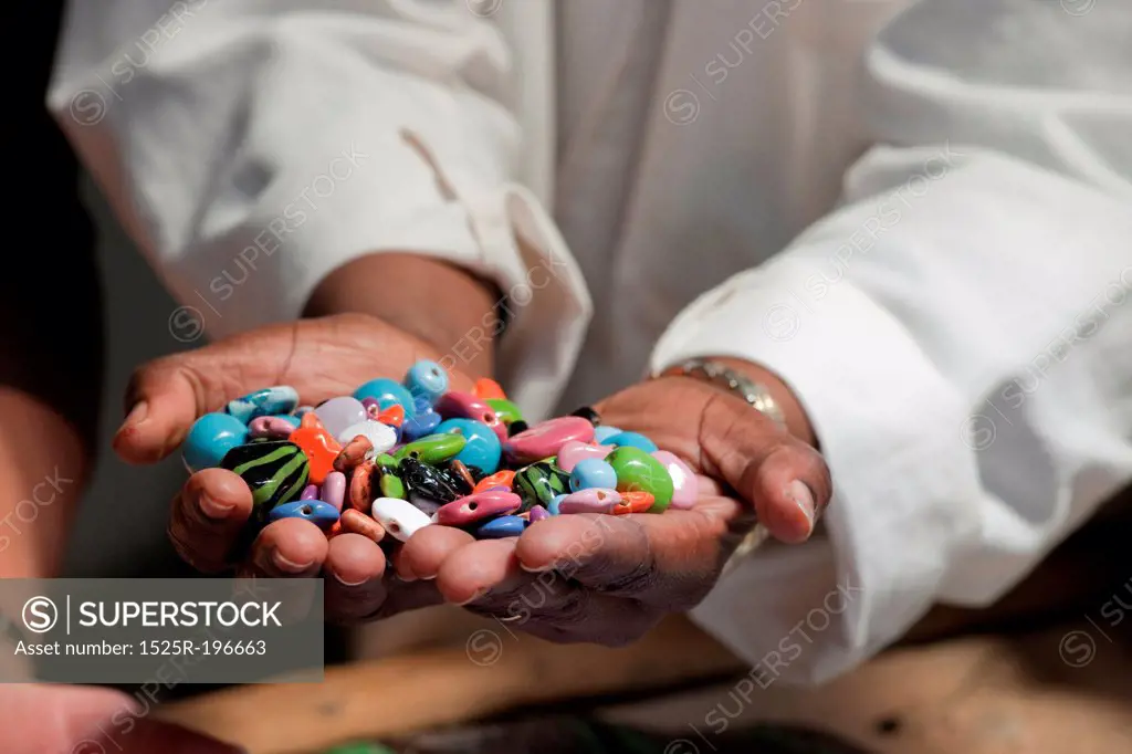 Hands holding colorful beads