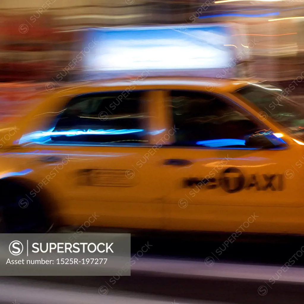 Blurred image of a yellow taxi in Manhattan, New York City, U.S.A.