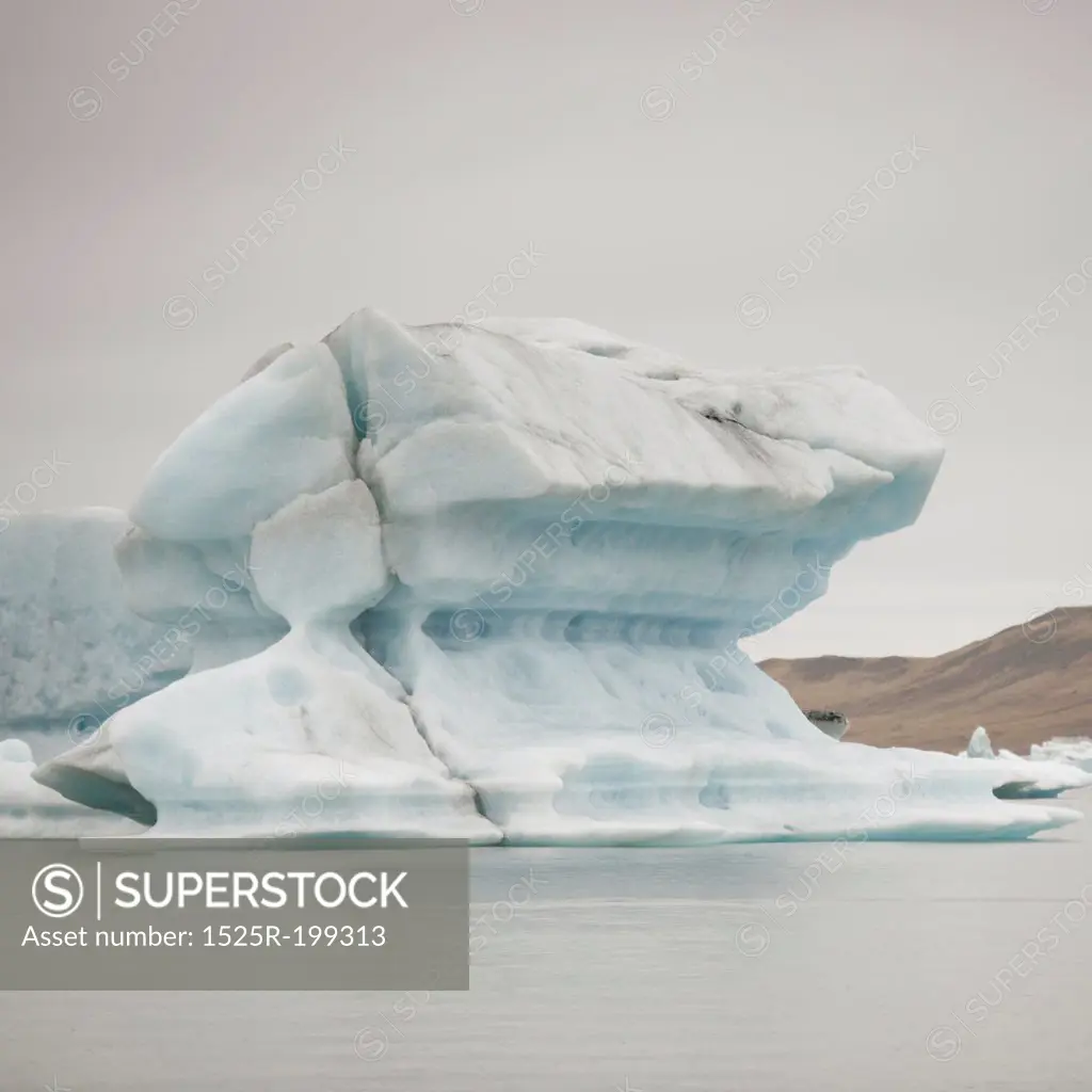 Calving iceberg floating in glacial lake