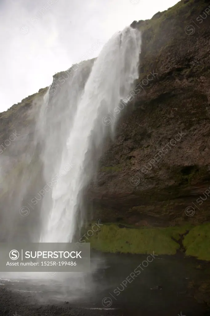 Waterfall over rocky cliffs in Iceland