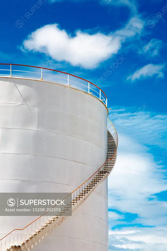 Industrial fuel tank against blue sky