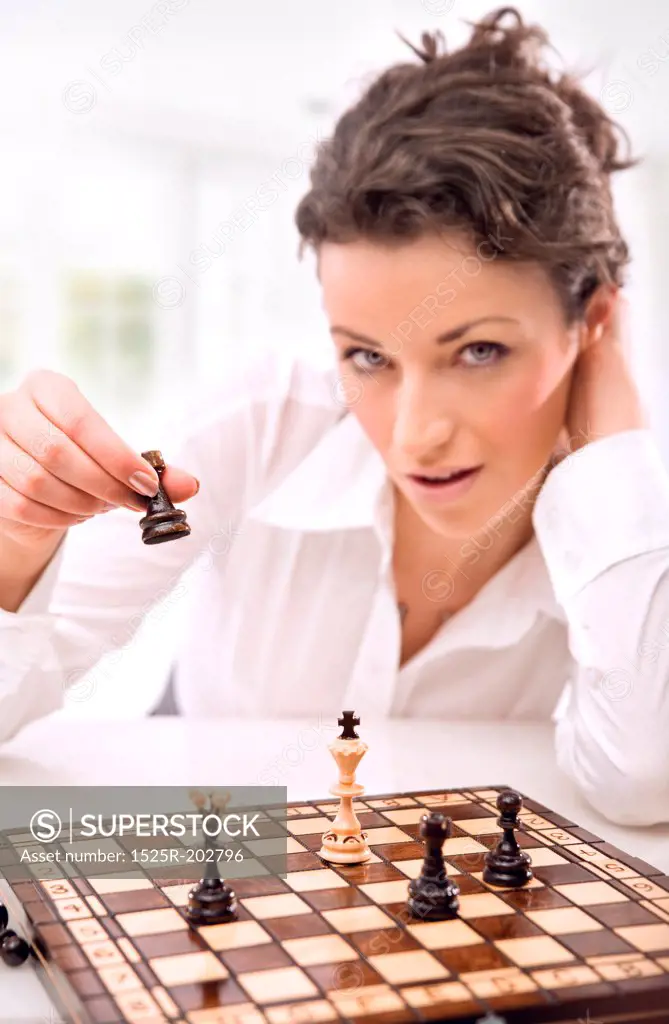 Young businesswoman playing chess