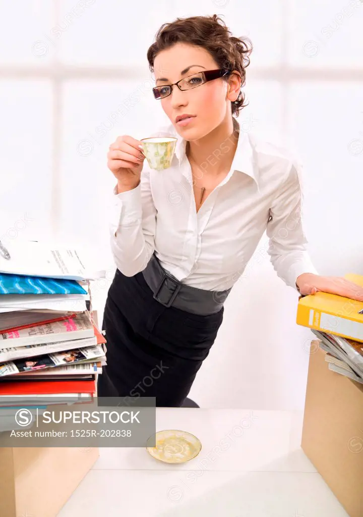 A businesswoman drinking coffee, thinking