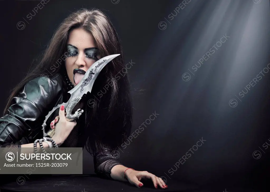 Attractive brunette beauty with knife