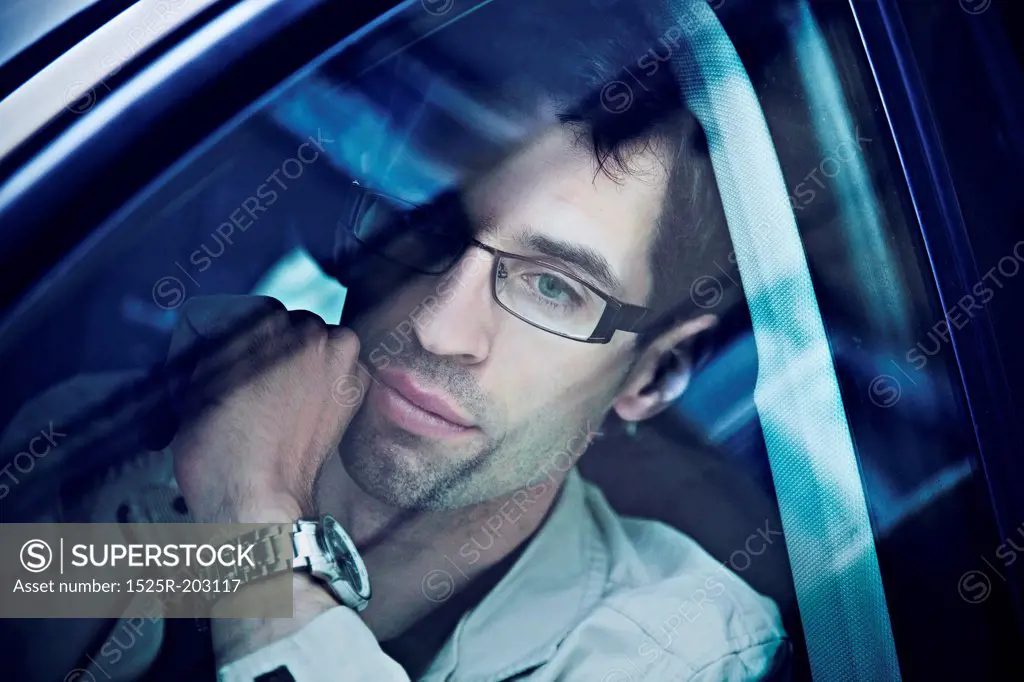 Handsome man sitting in a car