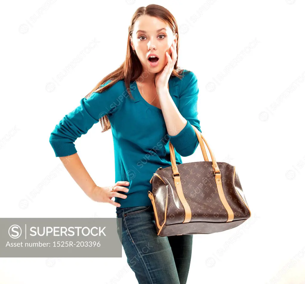 Young shocked brunette shopping isolated on white