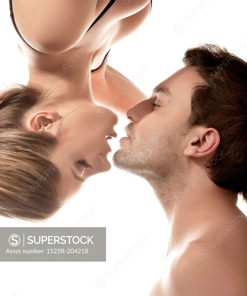 Conceptual portrait of a young couple gentle kissing