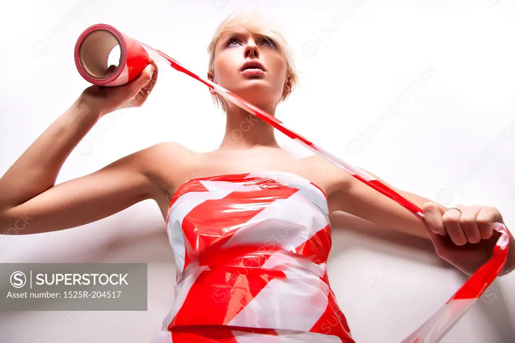 Portrait of beautiful blond woman with warning tape