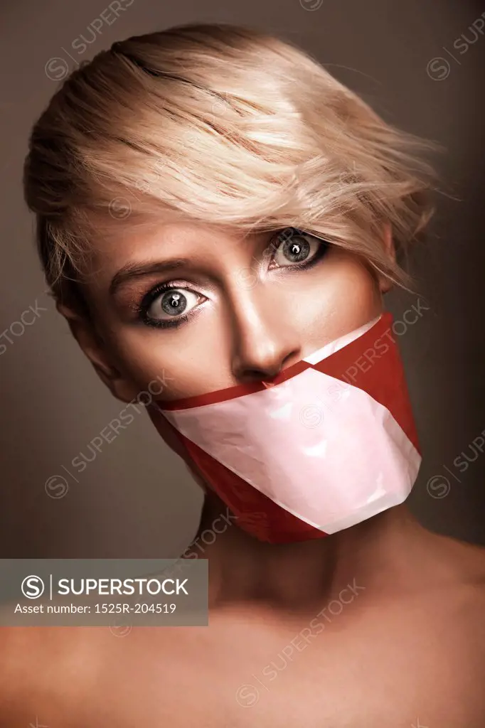 Woman's mouth sealed with a warning tape