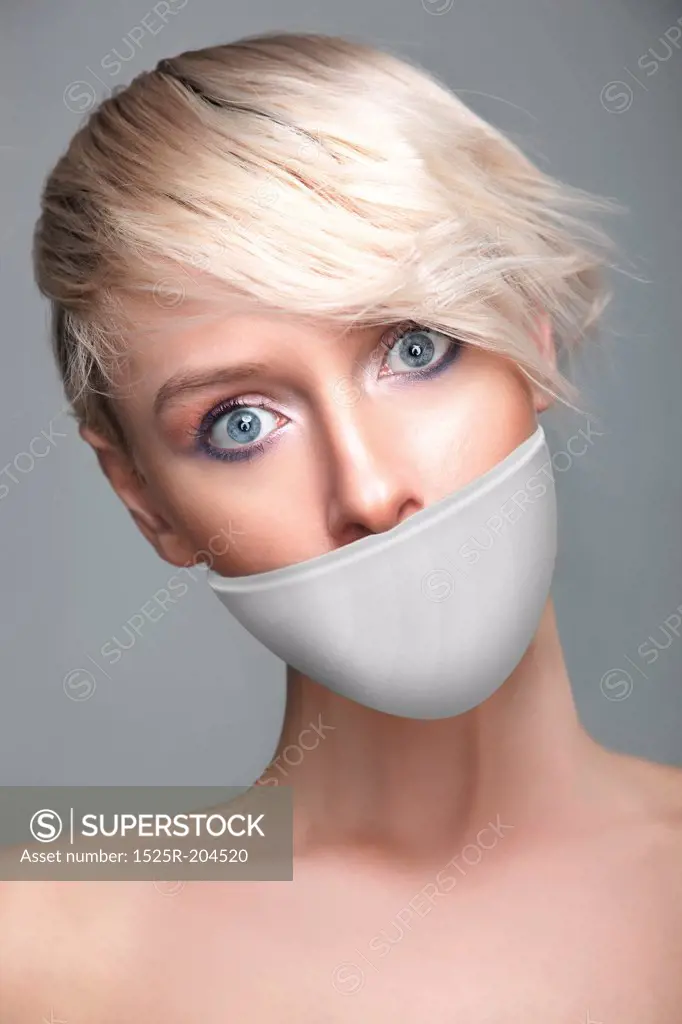 Cute young woman with white band on the mouth