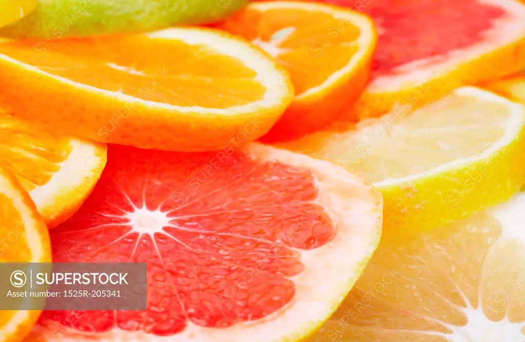 Sliced citrus fruits background closeup