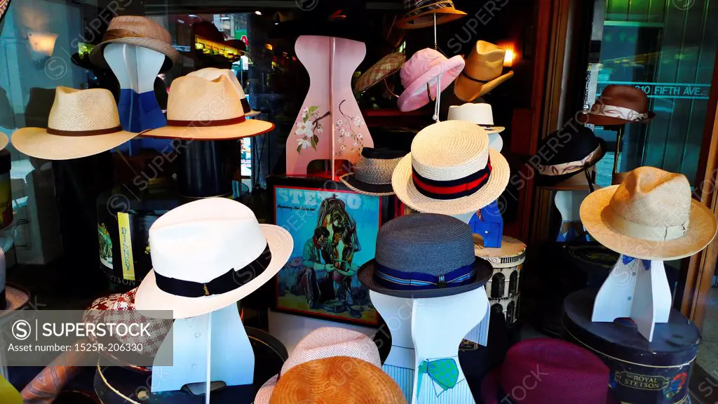 Various hats in a store window.