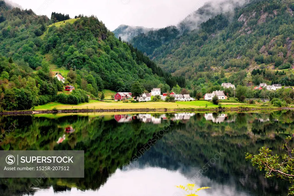 Village at waterfront in a valley, Bjorn Fjord, Hardangervidda, Hardanger, Norway