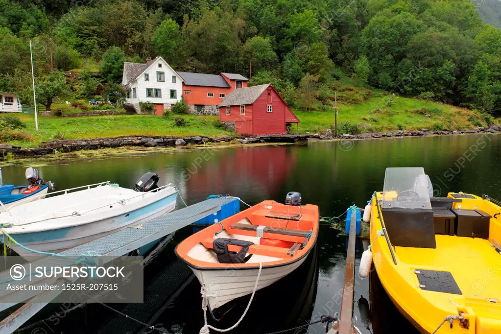 Boats moored with houses in the background, Hardanger, Hardangerfjord, Hardangervidda, Hardanger, Norway
