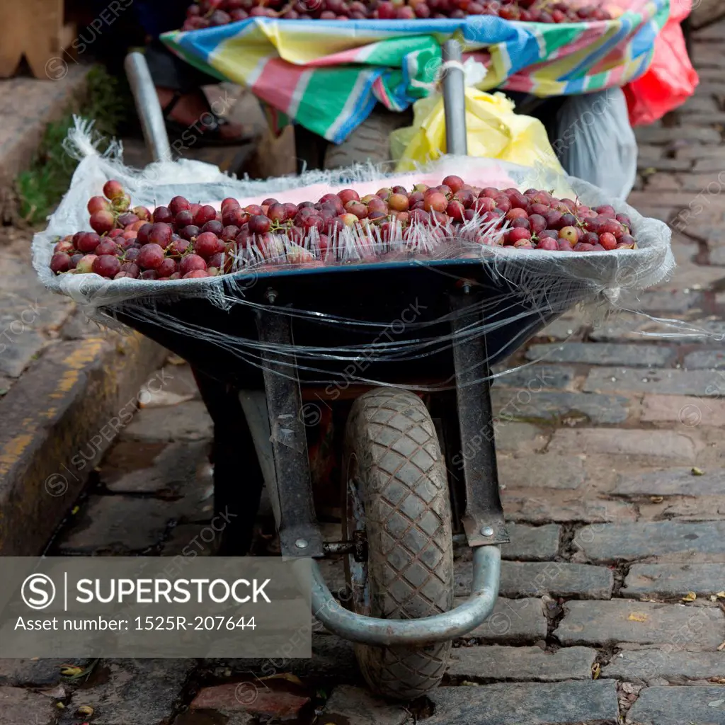 Plum for sale at a market stall on a wheelbarrow, Mercado Central, Cuzco, Peru