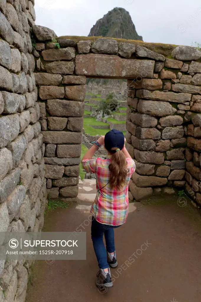 Girl photographing at The Lost City of The Incas, Machu Picchu, Cusco Region, Peru