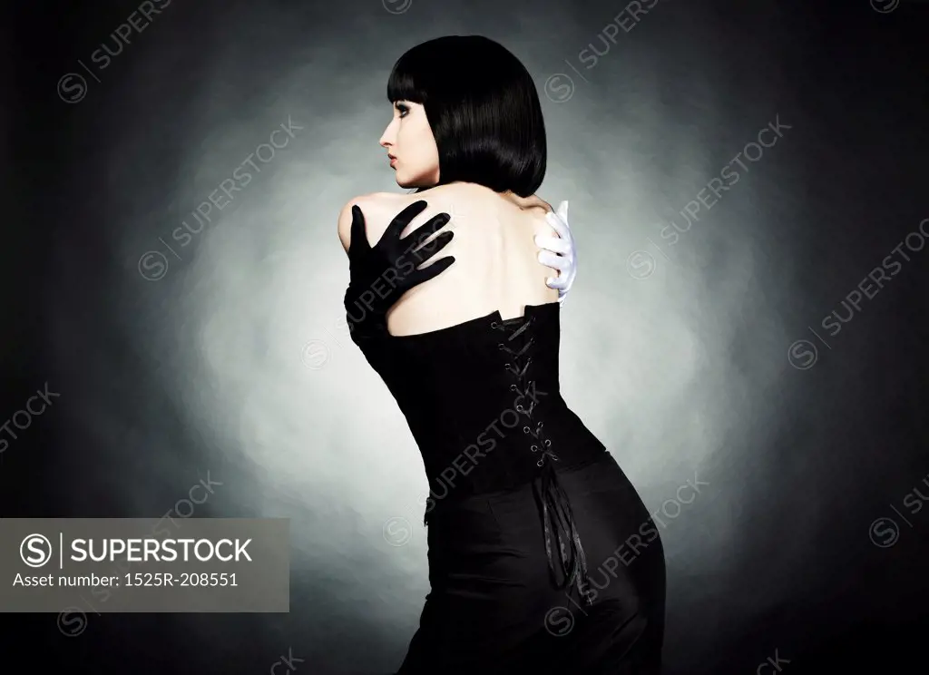 Fashion portrait of young beautiful woman in the black dress