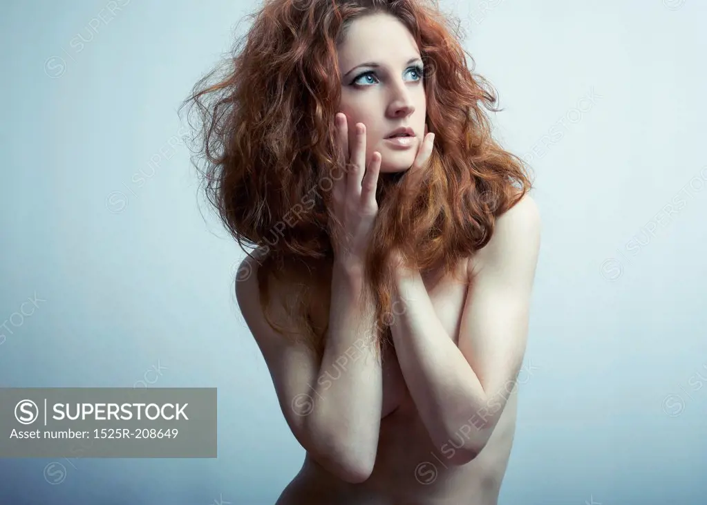 Fashion portrait of a young beautiful redheaded woman