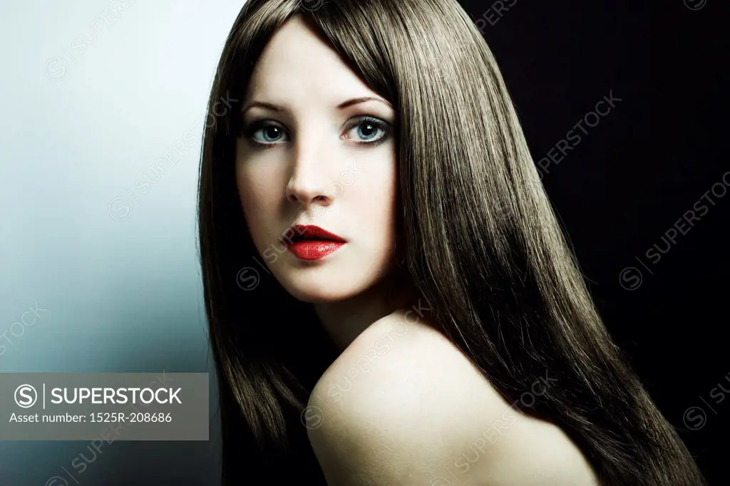 Fashion portrait of a young beautiful dark-haired woman