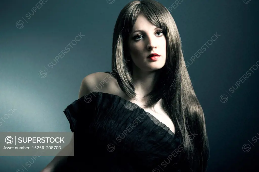 The young beautiful girl in black dress with developing hair
