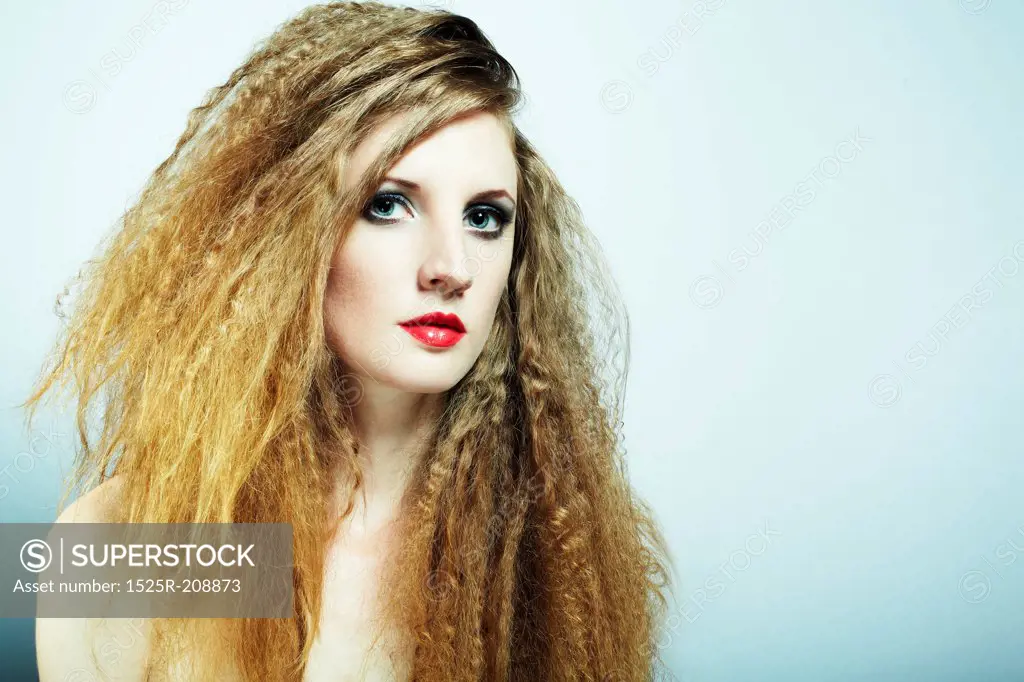 Fashion portrait of a young beautiful redhead woman