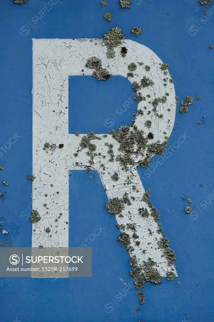 Decaying letter R on blue background
