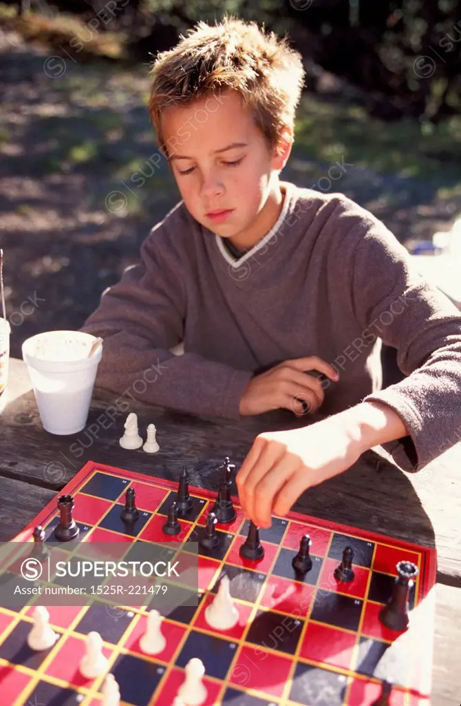 Young boy planning chess