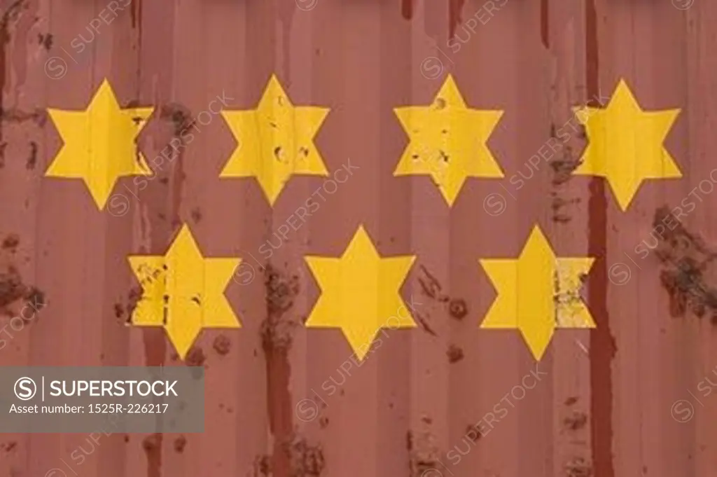 Yellow stars on red corrugated metal