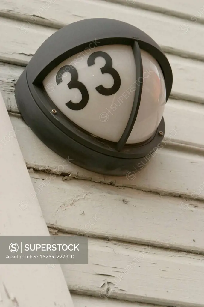 Outdoor light on wall with number 33 on it