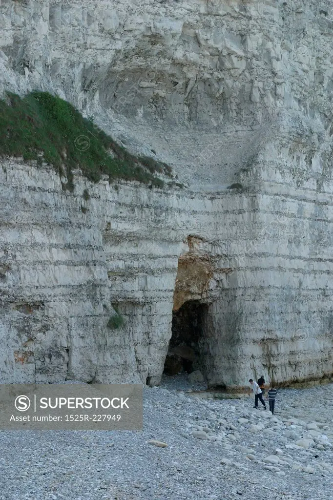 People stood at bottom of cliff
