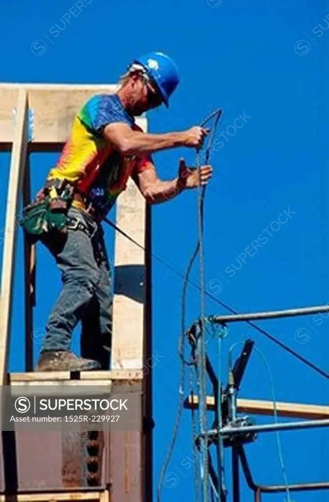Construction Worker Hauling up Rope