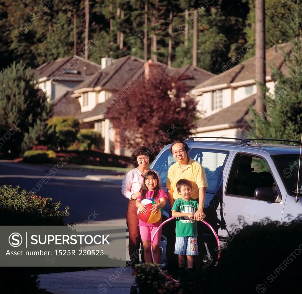 Family Standing by Minivan