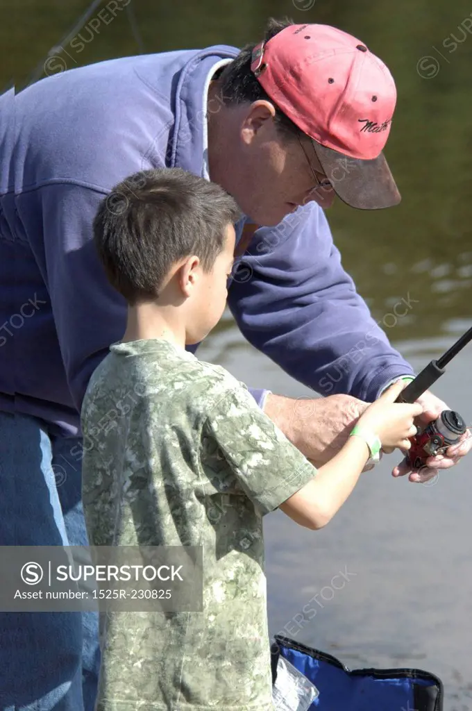 Man Showing Child How To Fish