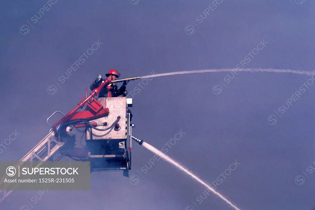 Fireman on Cherry Picker with Hose