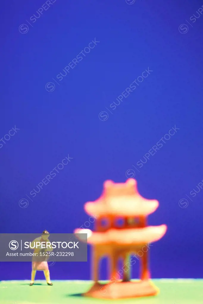 Toy Woman Taking Picture of Toy Pagoda