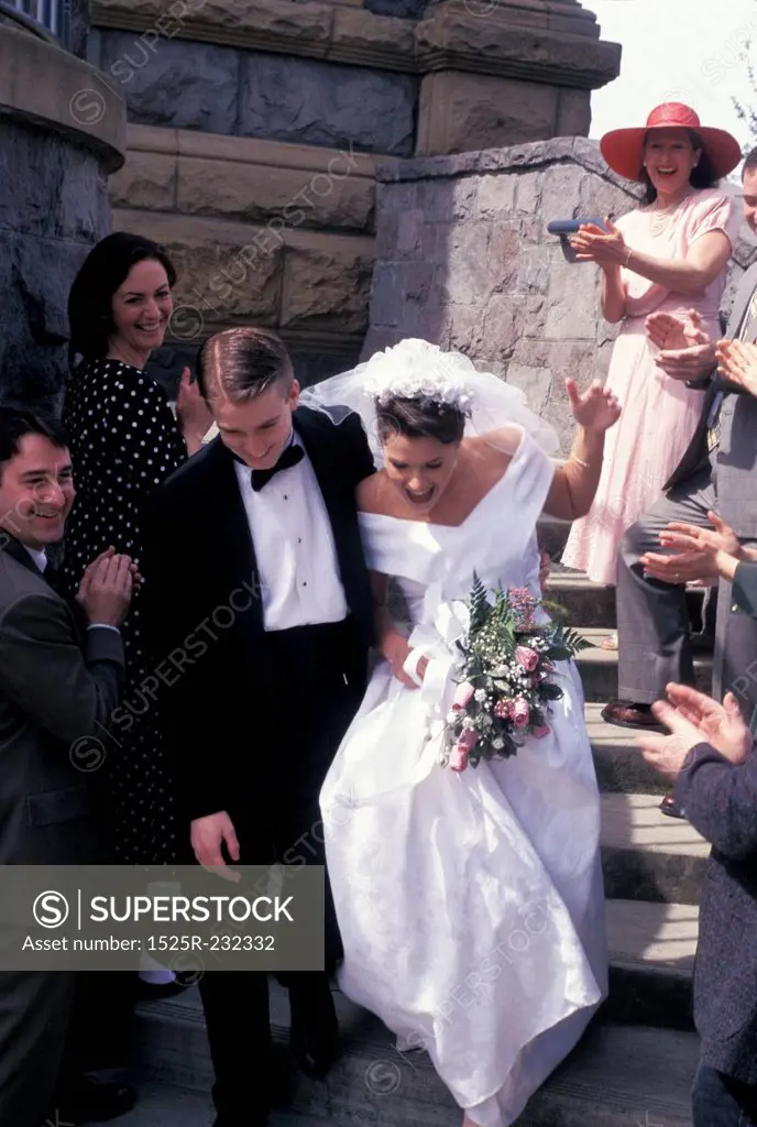 Bride And Groom Running Down Steps Of Church