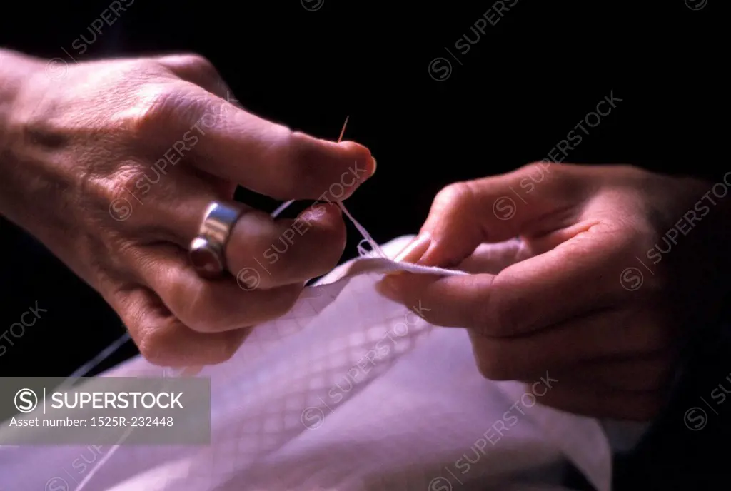 Hands Sewing on a Button