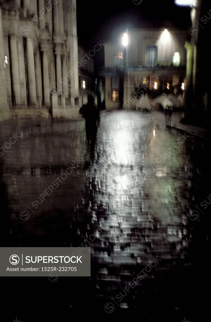Walking on a Rainy Street at Night