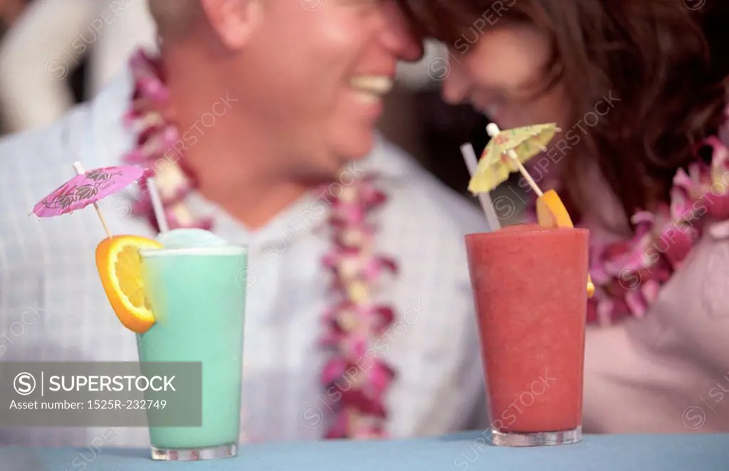 Couple Sharing A Happy Moment With Mixed Fruit Drinks In Hawaii