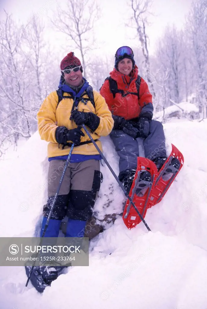 Man and Woman Taking a Break from Snowshoeing