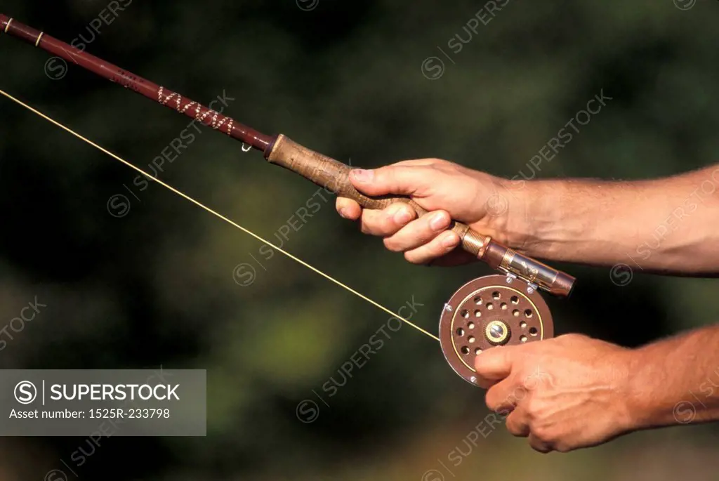 Hands Holding a Fishing Rod
