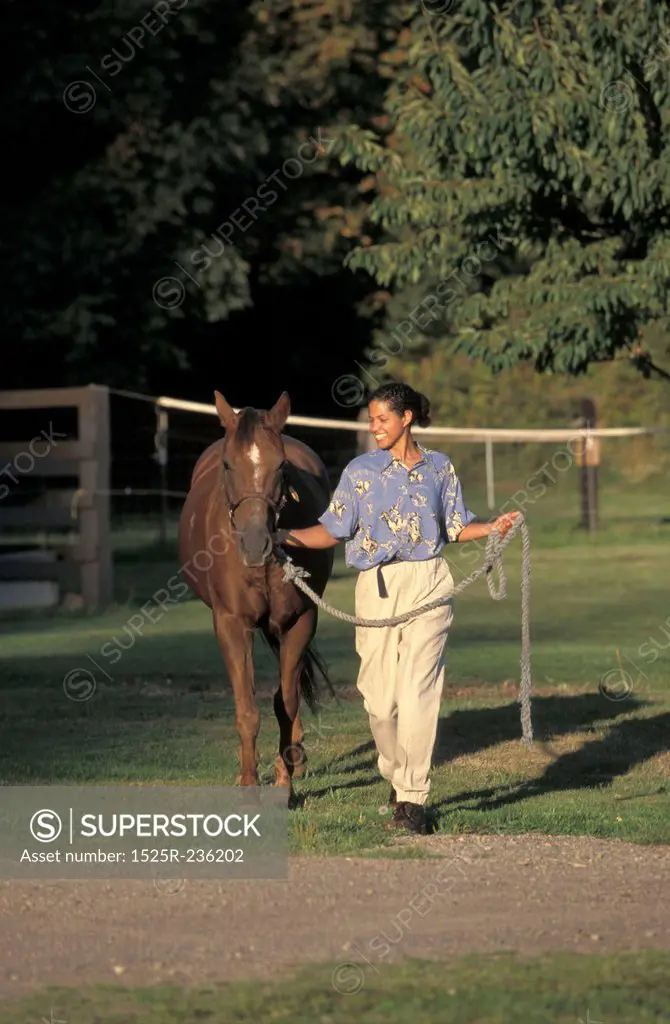 African American Woman Walking A Horse