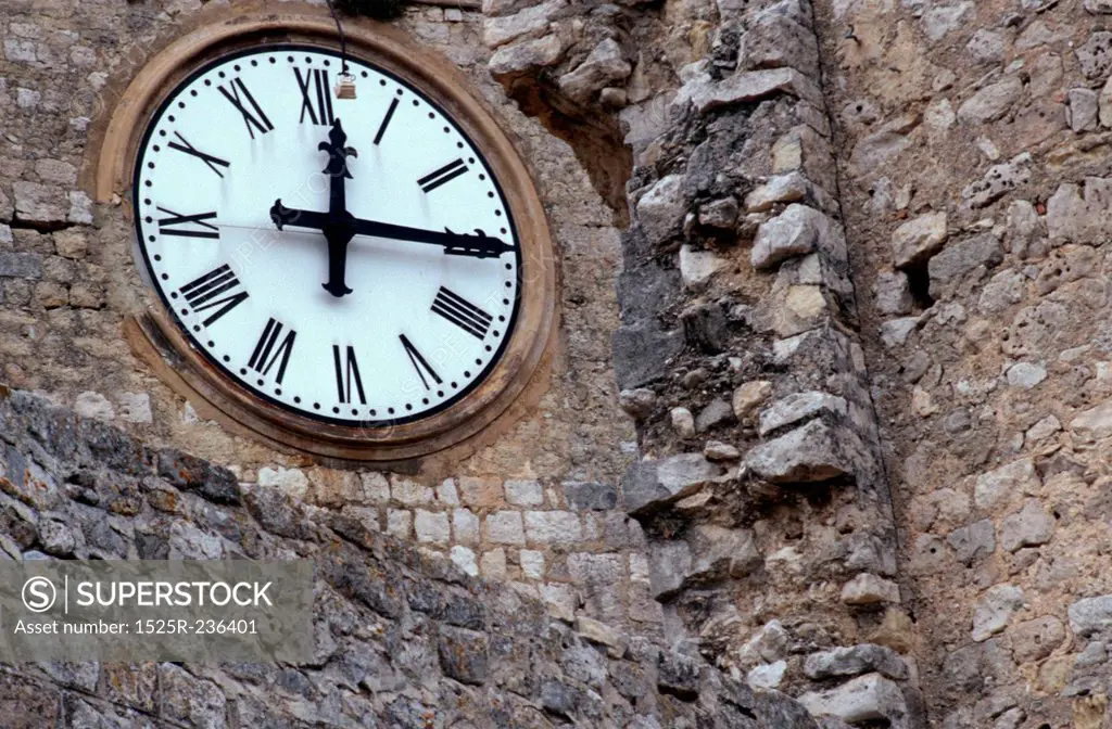 Clock in Crumbling Stone Wall